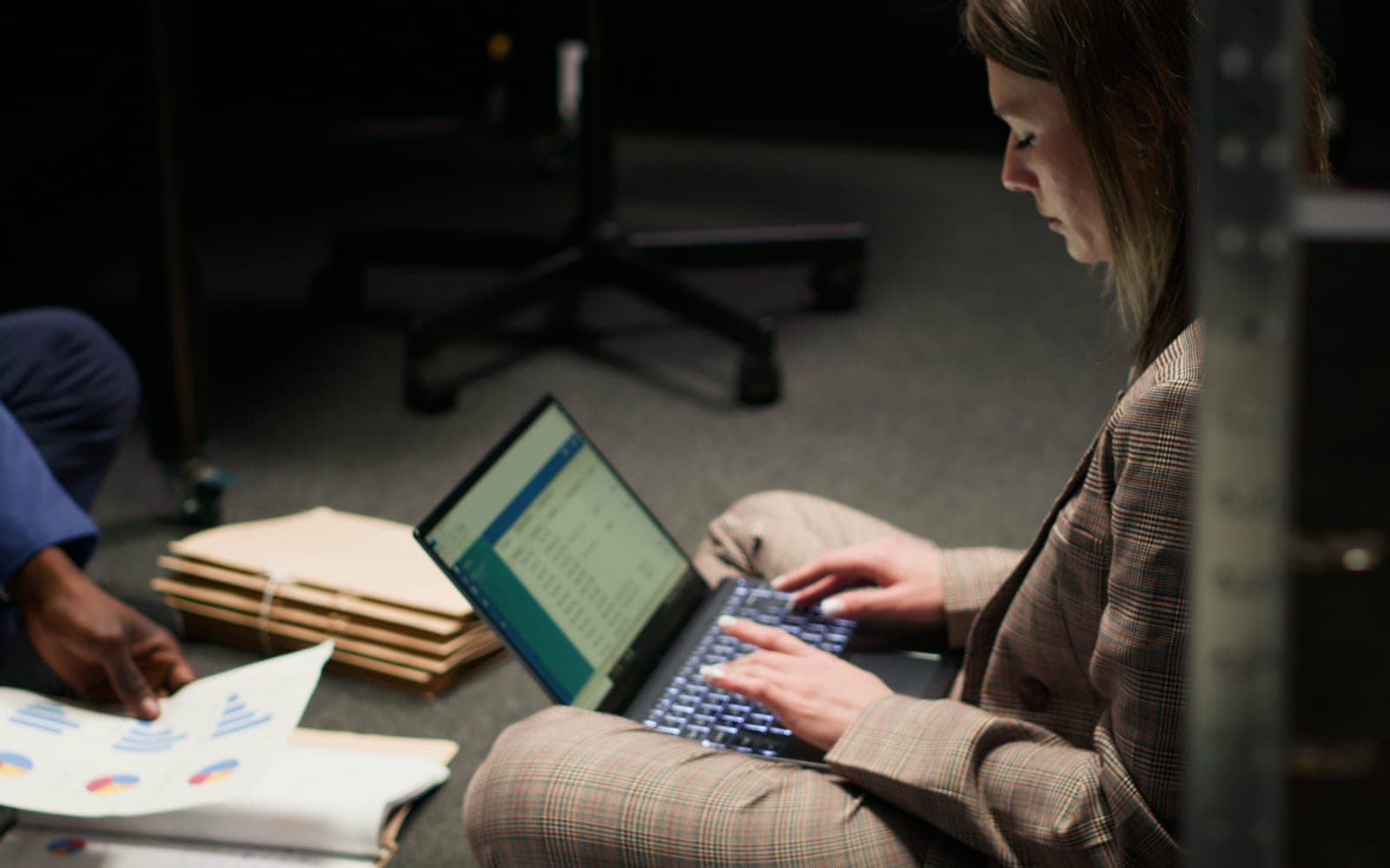 Investigator reviewing case materials with forensic documentation tools