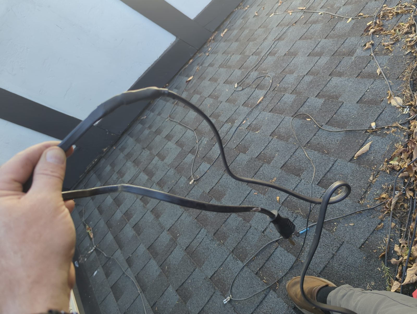 The repaired cable run across the roof shingles.